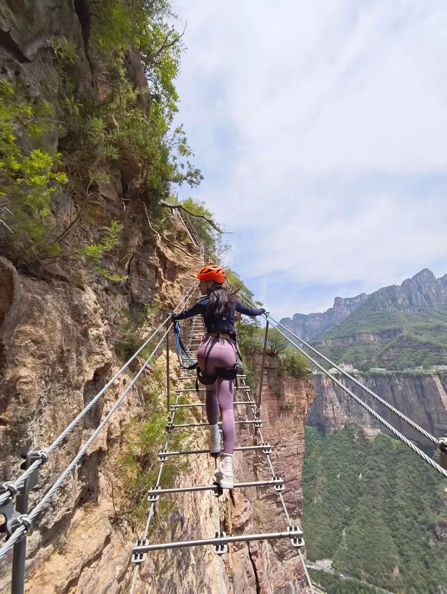 Bridge and ladder transition on Baoquan Via Ferrata challenge route